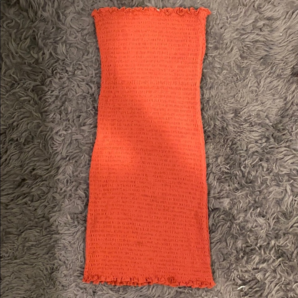 Peachy colored strapless body con dress